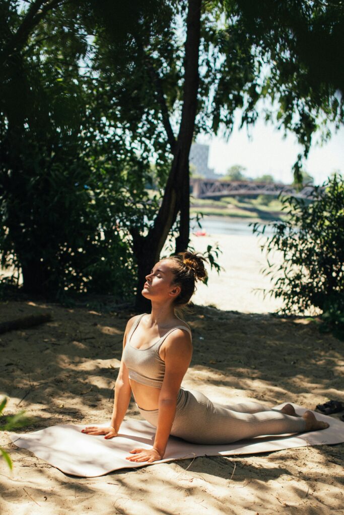 A Woman Doing Yoga on The Sand